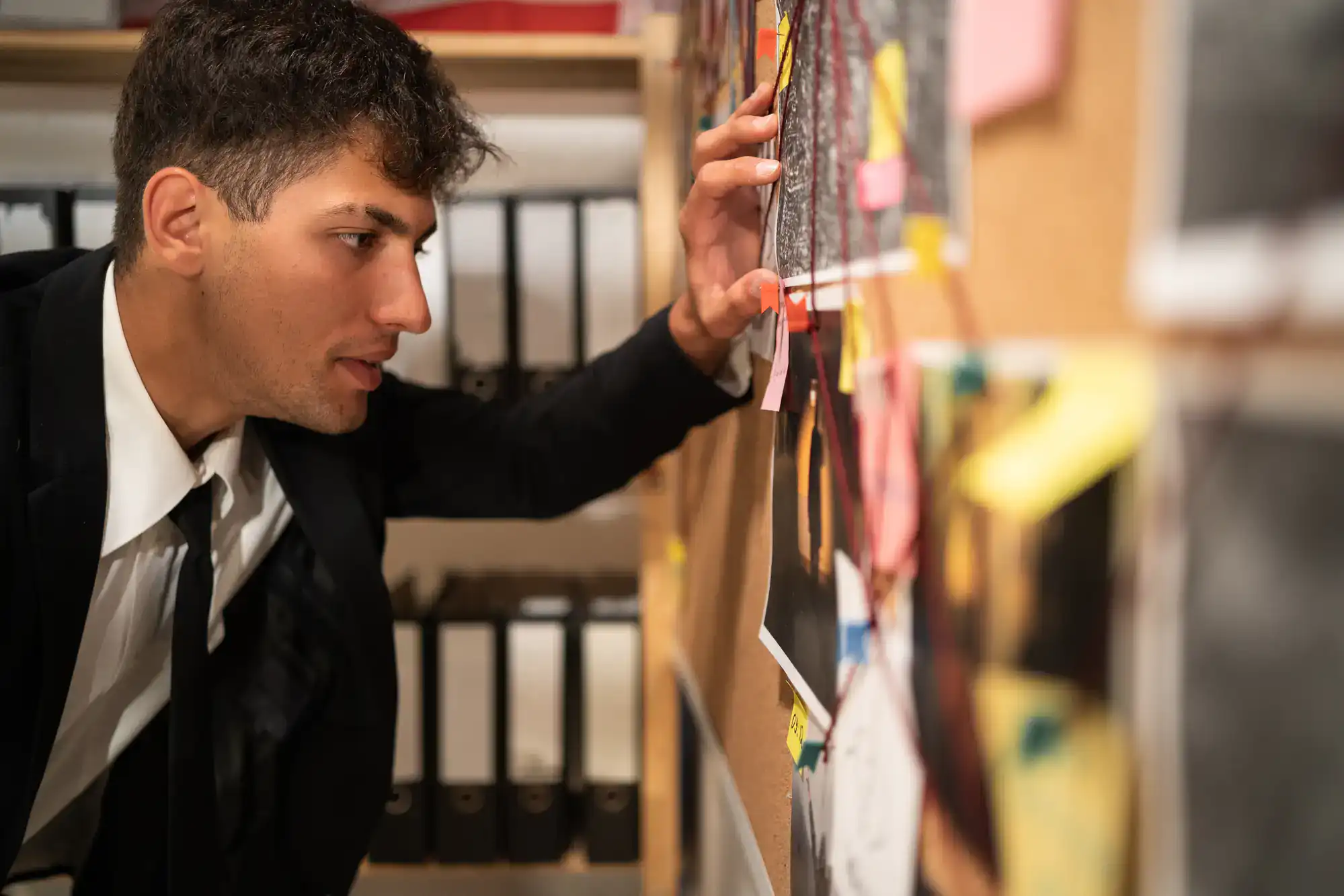Private Investigator Phoenix examines a crime board with photos, notes, and red strings in an AZ office.